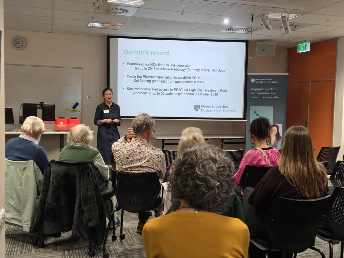 A speaker presenting at a NECNZ education day